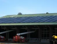A large building with solar panels on the roof.