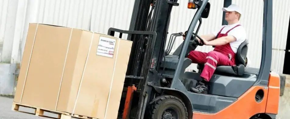 A forklift is loading boxes on to the truck.